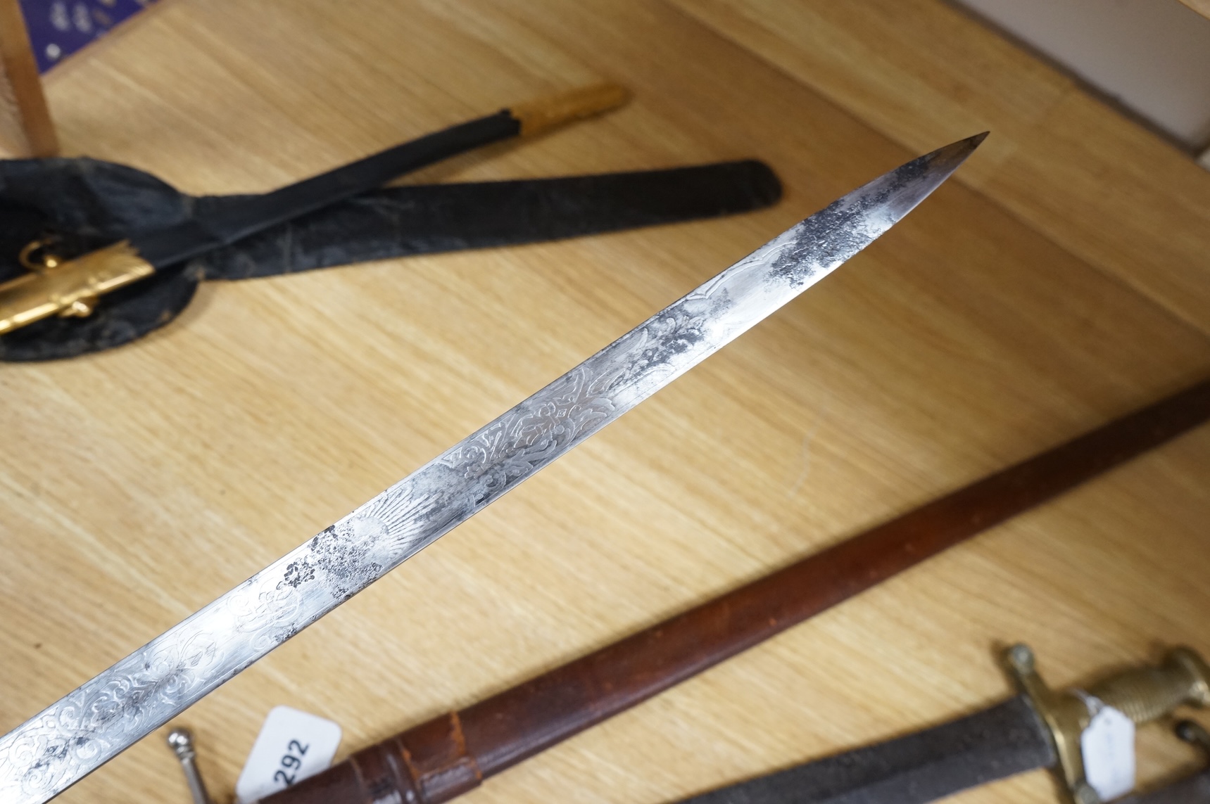 A post 1902 regulation Naval Officer’s dirk with lion’s head pommel, bullion dress knot, shark skin covered grip, in its leather scabbard, the gilt locket engraved with owners initials; CHCO’ R, the blade etched with cro